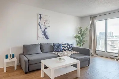a living room with a couch and a table at 1BR Downtown MTL - Walk to Old Port in Montréal