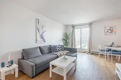 a living room with a couch and a table at 1BR Downtown MTL - Walk to Old Port in Montréal