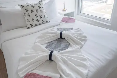 a white bed with a bow tie on it at Downtown Montreal 1BR - Sleeps 4 in Montréal