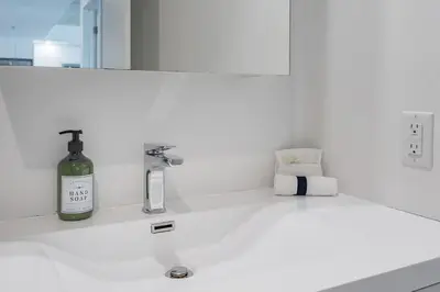 a bottle of wine sitting on a bathroom sink at Downtown Montreal 1BR - Sleeps 4 in Montréal