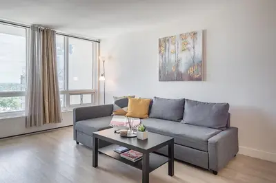 a living room with a couch and a table at Modern 1BR - Central Location in Montréal