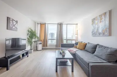 a living room with a couch and a tv at Modern 1BR - Central Location in Montréal