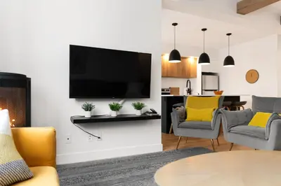 a living room with a flat screen tv on a wall at Magnifique Condo pour 4 à Orford in Magog-Orford
