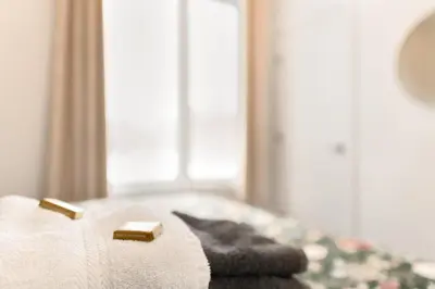 a bed with a towel and a bar of soap on it at Magnifique Condo pour 4 à Orford in Magog-Orford