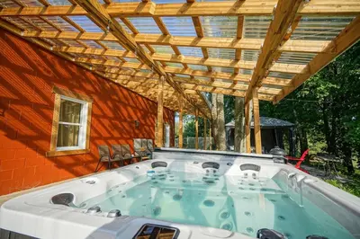 a hot tub in a house with a wooden roof at Bashtina Inn and Spa in Saint-Césaire
