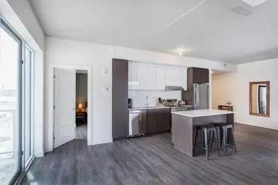 a large kitchen with a counter top and a kitchen island at Corporate Stays Equinoxe 2 Bedroom in Laval