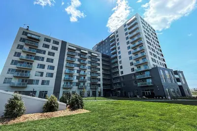 two tall buildings with grass in front of them at Corporate Stays Monarc 2 Bedroom in Montréal