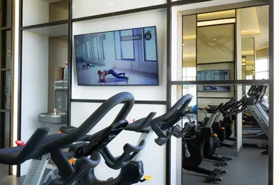 a gym with treadmills and a flat screen tv at Corporate Stays Monarc 2 Bedroom in Montréal