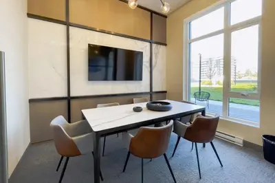 a dining room with a table and chairs and a tv at Corporate Stays Monarc 2 Bedroom in Montréal