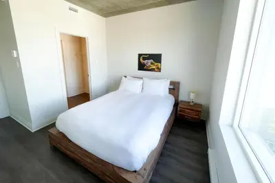 a white bed in a room with a window at Corporate Stays Monarc 2 Bedroom in Montréal