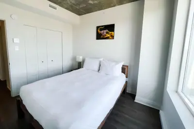 a bedroom with a white bed and a window at Corporate Stays Monarc Bedroom in Montréal