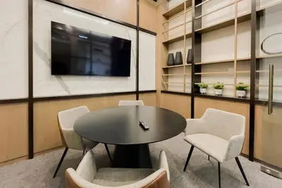 a conference room with a table and chairs and a tv at Corporate Stays Monarc Bedroom in Montréal