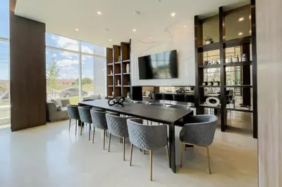 a dining room with a black table and chairs at Corporate Stays Monarc Bedroom in Montréal