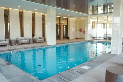 a large swimming pool with blue water in a building at Corporate Stays Monarc Bedroom in Montréal