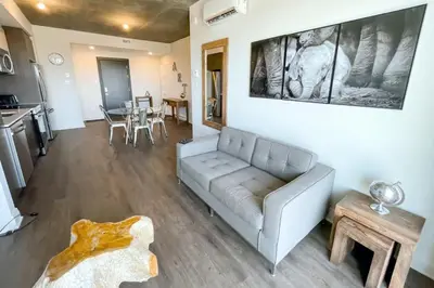 a living room with a couch and a table at Corporate Stays Monarc Bedroom in Montréal