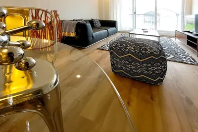 a living room with a glass table and a couch at Corporate Stays Blum 1 Bedroom in Brossard
