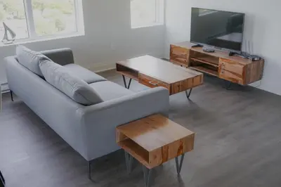 a living room with a couch and a table and a tv at Corporate Stays Monarc 2 Bedrooms in Montréal
