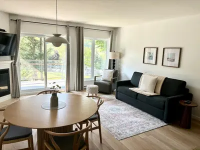 a living room with a couch and a table at Ski in out condo sur la montagne in Bromont