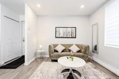 a living room with a couch and a table at Modern Apartment in Montreal in Montréal