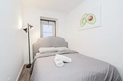 a bedroom with a bed with towels on it at Modern Apartment in Montreal in Montréal