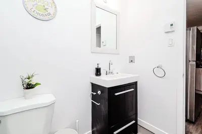 a bathroom with a sink and a toilet at Modern Apartment in Montreal in Montréal