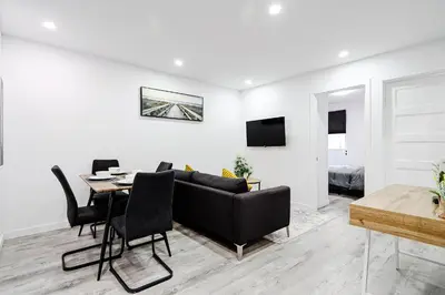 a living room with a couch and a table at Appartement 2 chambres Downtown Montréal in Montréal