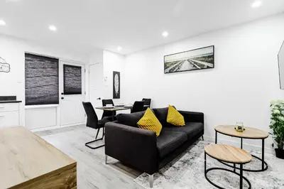 a living room with a couch and a table at Appartement 2 chambres Downtown Montréal in Montréal