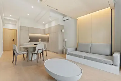 a living room with a couch and a table and chairs at Miles by Alta in Montréal