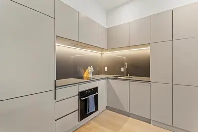 a kitchen with white cabinets and a stove at Miles by Alta in Montréal