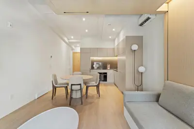 a living room with a table and chairs and a couch at Miles by Alta in Montréal