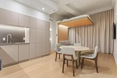 a kitchen and dining room with a table and chairs at Miles by Alta in Montréal