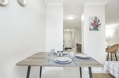 a dining room with a table with plates on it at Séjour idéal au cœur de Montréal in Montréal