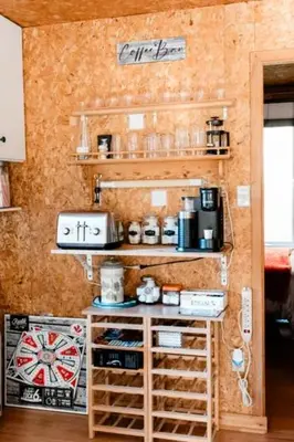 a room with a wall with two shelves and a counter at Chalet Le Mona in Notre-Dame-Des-Bois