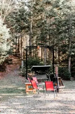 a group of chairs sitting in front of a piano at Chalet Le Mona in Notre-Dame-Des-Bois