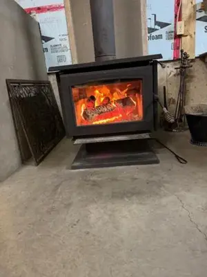 a fireplace with a fire in it in a room at Chalet Le Mona in Notre-Dame-Des-Bois