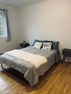 a bedroom with a bed with two pillows on it at Urban Comfort 3BR Apartment in NDG in Montréal