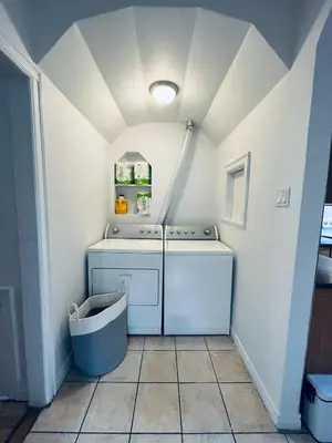 a laundry room with a washer and dryer at Urban Comfort 3BR Apartment in NDG in Montréal