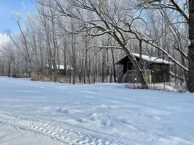 a cabin in the snow with footprints in the snow at chalet 2 - Domaine de l'Archipel in Sorel