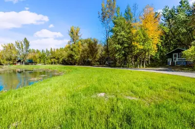 a large grassy field with a house in the background at chalet 2 - Domaine de l'Archipel in Sorel