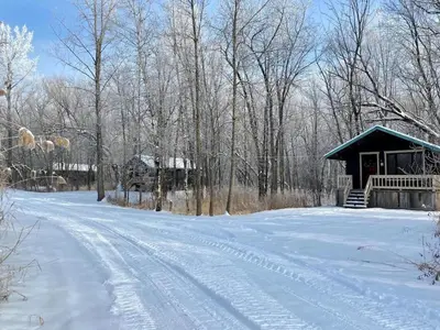 a snow covered road leading to a cabin at chalet 5 Domaine de l'Archipel in Sorel