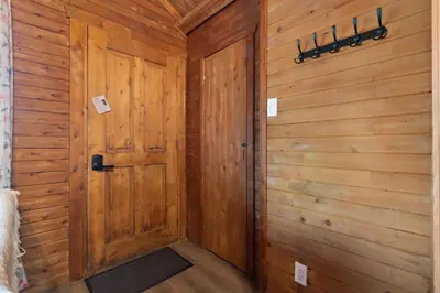 a wooden hallway with a door in a room at chalet 5 Domaine de l'Archipel in Sorel