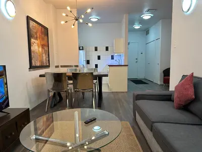 a living room with a couch and a table at Cozy Open Space in Montréal