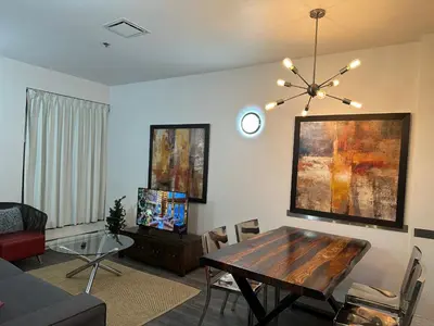a living room with a table and a couch at Cozy Open Space in Montréal