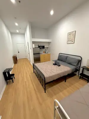a large room with a bed and a kitchen at Big studio 4 persons apartment with Private FREE Parking in Montréal