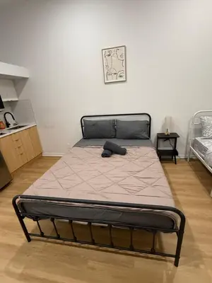 a bed in a room with a bed frame at Big studio 4 persons apartment with Private FREE Parking in Montréal