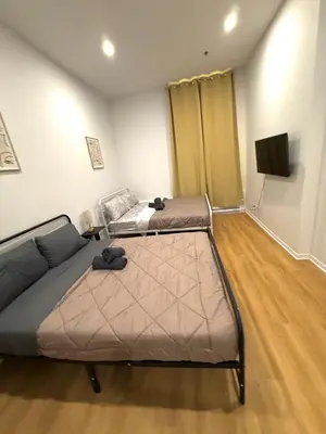 a living room with two beds and a couch at Big studio 4 persons apartment with Private FREE Parking in Montréal