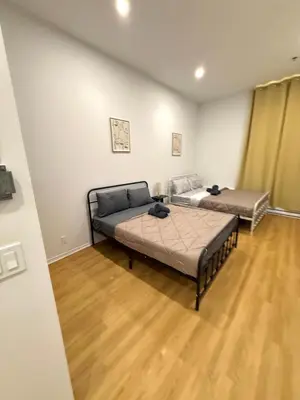 two beds in a room with wooden floors at Big studio 4 persons apartment with Private FREE Parking in Montréal