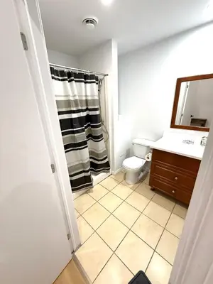 a bathroom with a sink and a toilet and a mirror at Big studio 4 persons apartment with Private FREE Parking in Montréal