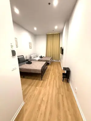 a bedroom with a bed and a couch in a room at Big studio 4 persons apartment with Private FREE Parking in Montréal