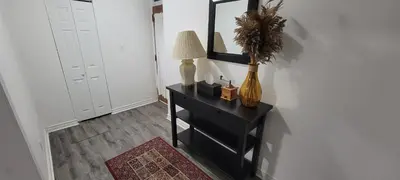 a room with a table with a lamp and a mirror at Comfortable condo in Montreal in Montréal